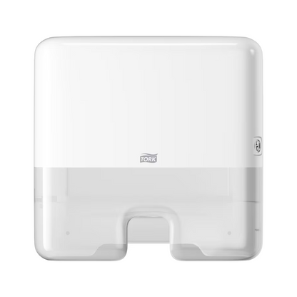 The Tork Xpress® 552100 Mini Dispenser for Multifold Hand Towels Elevation H2 by TORK – Essity Professional Hygiene Germany GmbH is an elegant, white, wall-mounted paper towel dispenser. It features a transparent section with the Tork logo, a central opening for easy single sheet dispensing of multifold towels, and a secure side closure.