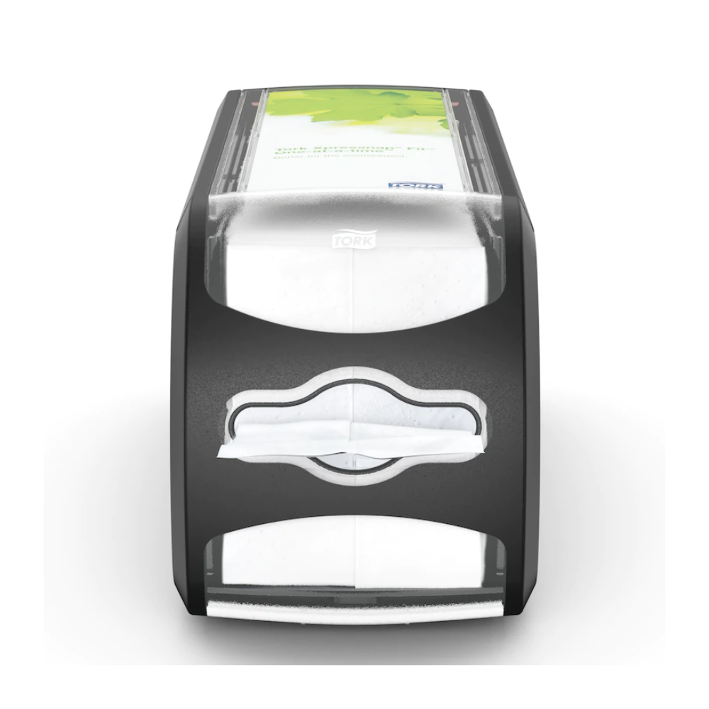 Pictured is the napkin dispenser Tork Xpressnap Fit® 272901 from Essity Professional Hygiene Germany GmbH. This black-gray dispenser has a transparent front containing white napkins and a green advertising space on the top. The 'Tork' logo is visible and highlights the efficient single napkin dispensing system of the Tork Xpressnap Fit.