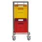 The Novocal recycling collector features a stainless steel frame and four wheels, carrying two colored plastic containers: the upper yellow container labeled "PLASTIC" and the lower red container labeled "METAL" for organized recycling.